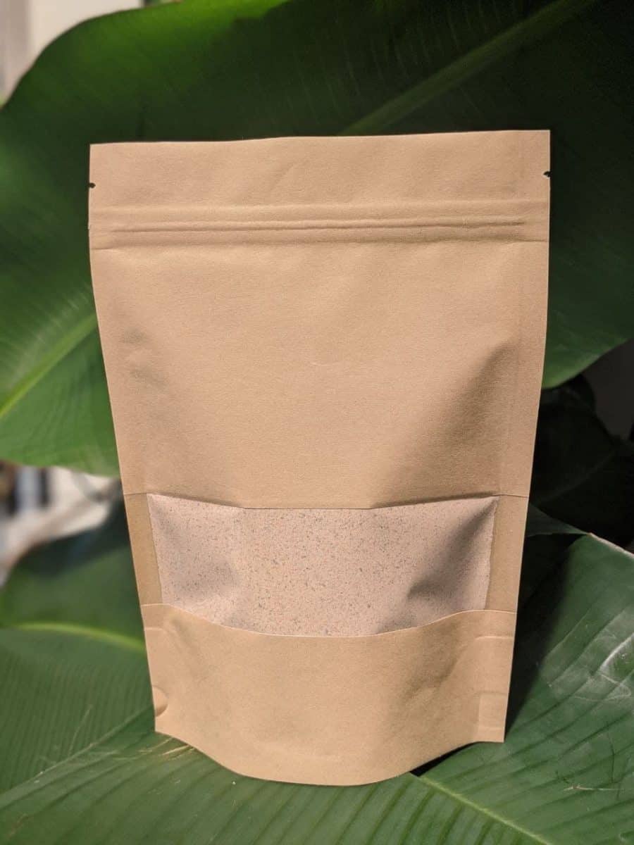 A brown bag with a leaf sitting on top of it.