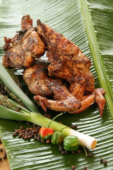 Grilled chicken on a banana leaf.
