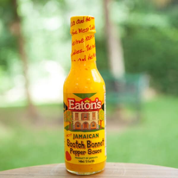 A bottle of eaton's jamaica hot sauce sitting on a table.