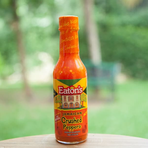 A bottle of eaten's hot sauce sitting on a table.