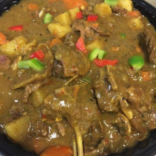 A bowl of stew with meat and vegetables in it.