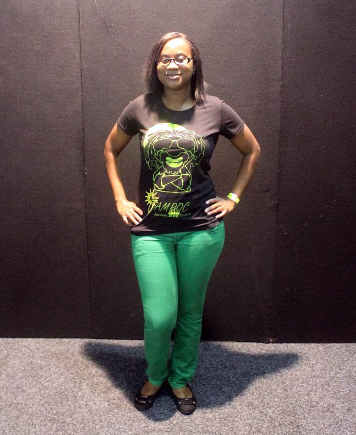 A woman wearing a green Jamroc T-Shirt.